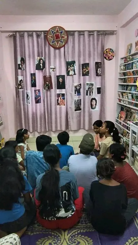 Two facilitators address a seated group at the Zubeen Divas gathering in a NEET library