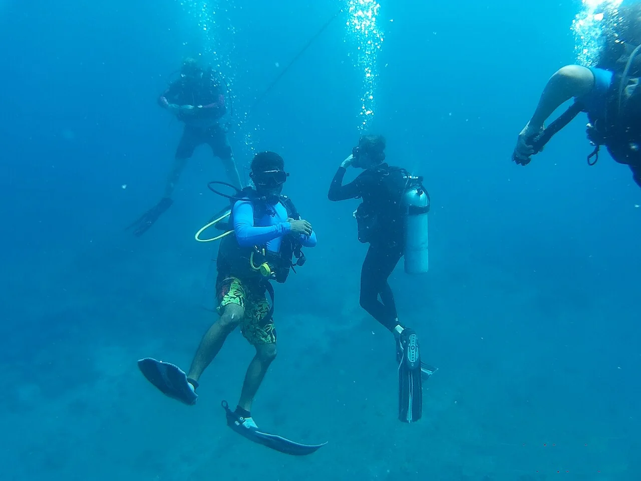 Scuba divers exploring pristine coral reef biodiversity in the Andaman Sea